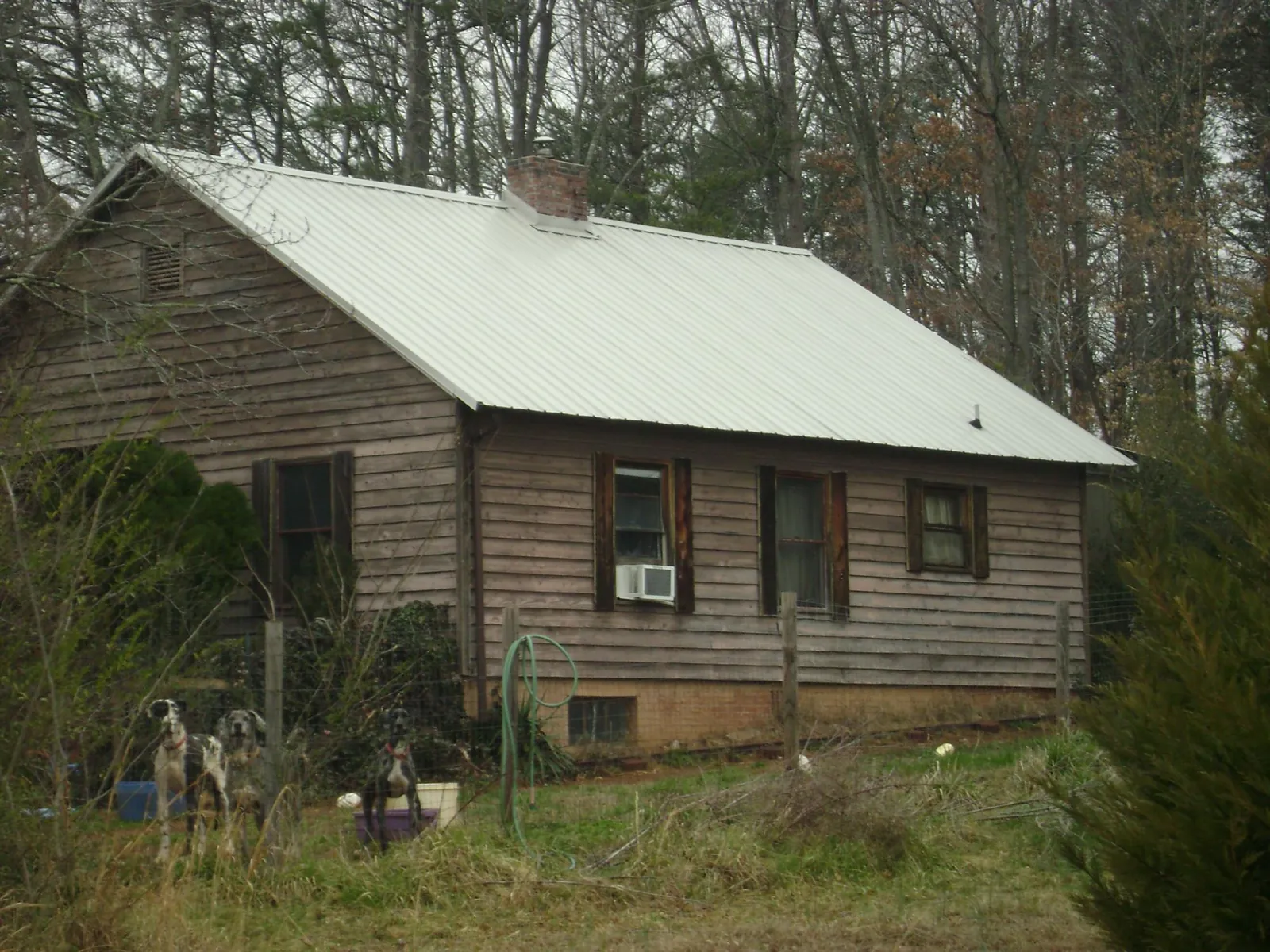 White metal roof on an old wood sided farmhouse, from a Metal Roof Installation job in Copper Hill